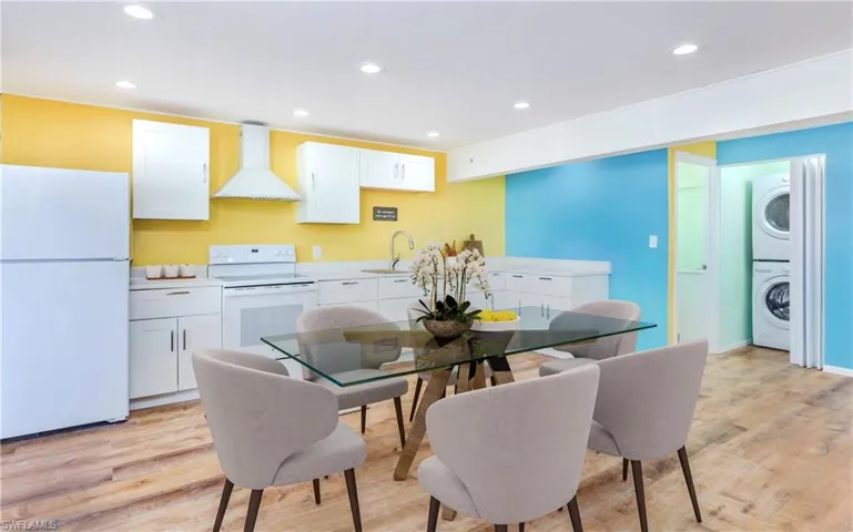Dining area featuring recessed lighting, stacked washer and clothes dryer, and light wood-style flooring
