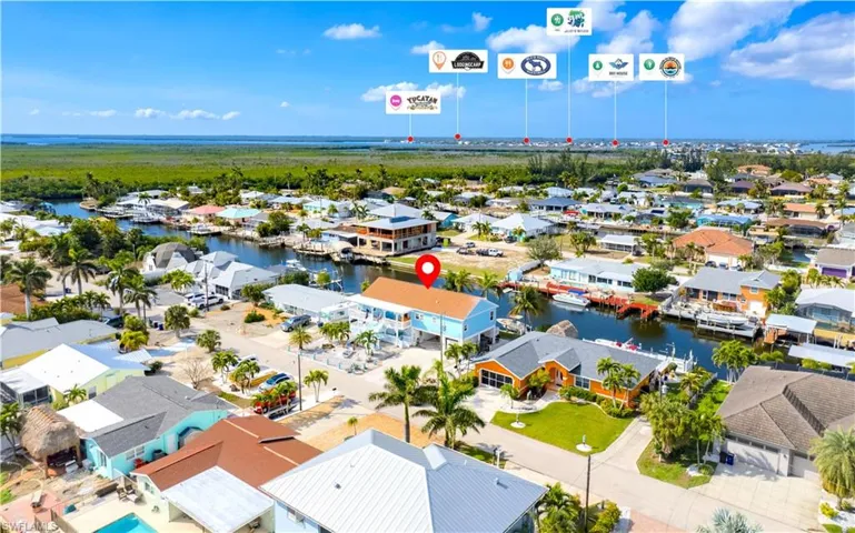Aerial view of residential area featuring a nearby body of water