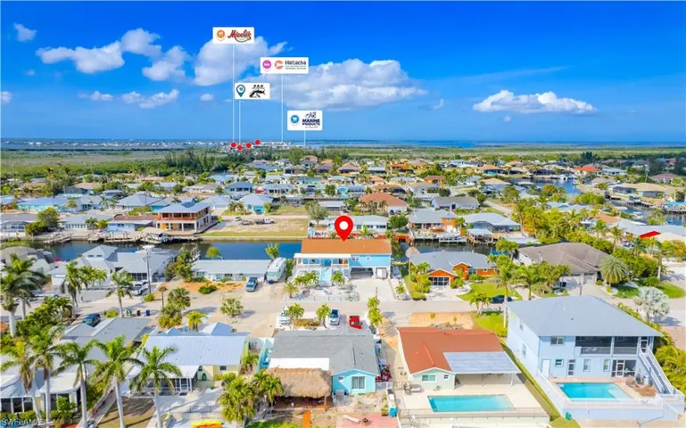 Aerial perspective of suburban area featuring a large body of water