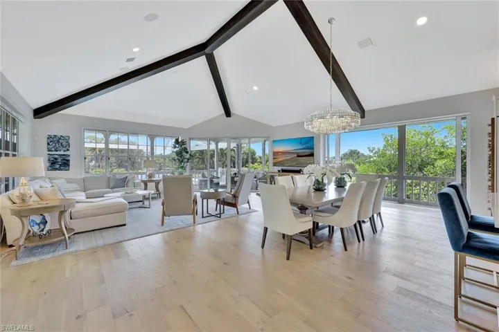 Formal dining space adjacent to the great room with water views beyond.