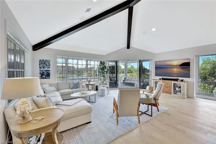 Imagine relaxing riverside in this great room featuring vaulted ceilings, ceiling beams and panoramic water views.