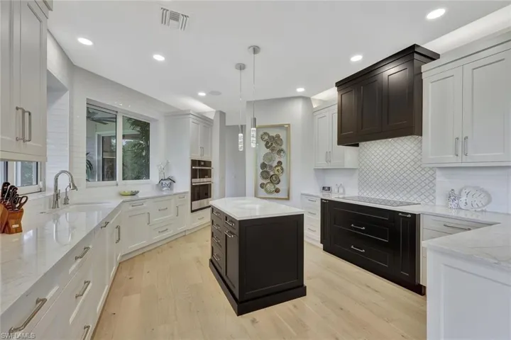 Notice all of the drawer space, the center island, quartz countertops, stainless appliances, walk-in pantry, and more.