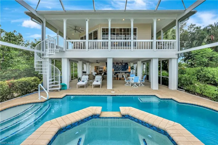 View of rear of home while standing riverside.