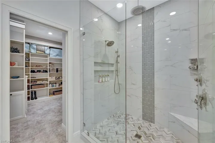 Primary ensuite bathroom with luxury tile detail.