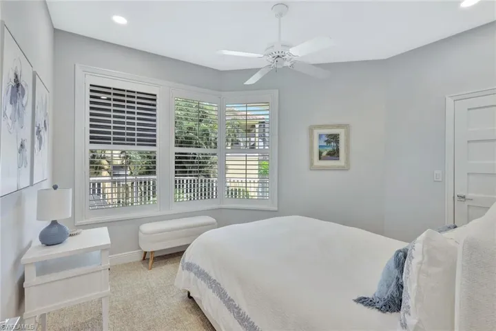 Bright and airy guest bedroom located on upper level.