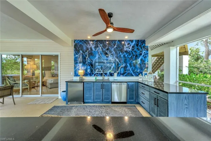 The outdoor kitchen, located on the lower level boasts granite countertops, waterproof pvc cabinetry, and brand new appliances.