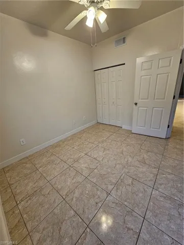 Unfurnished bedroom featuring a closet and a ceiling fan