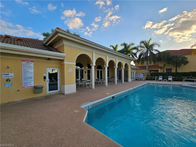 Community pool with a patio