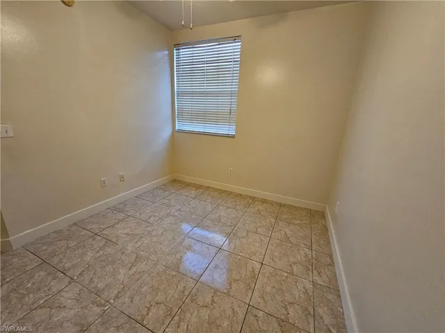 Spare room featuring baseboards