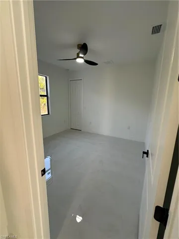 Spare room with ceiling fan