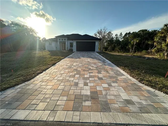 View of front of house featuring a front yard and a garage
