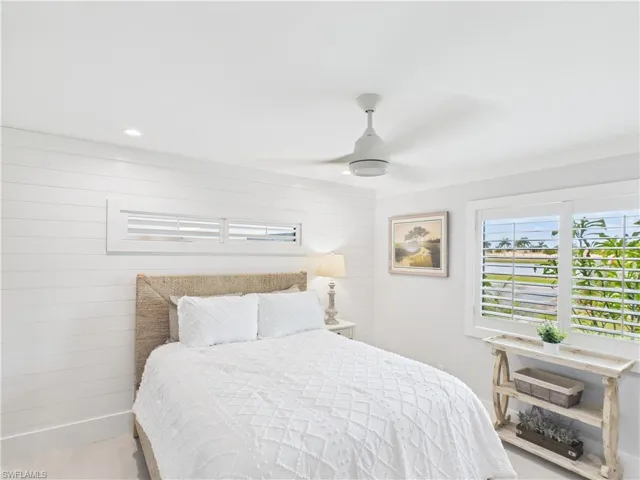 White shiplap accent wall with a horizontal transom window