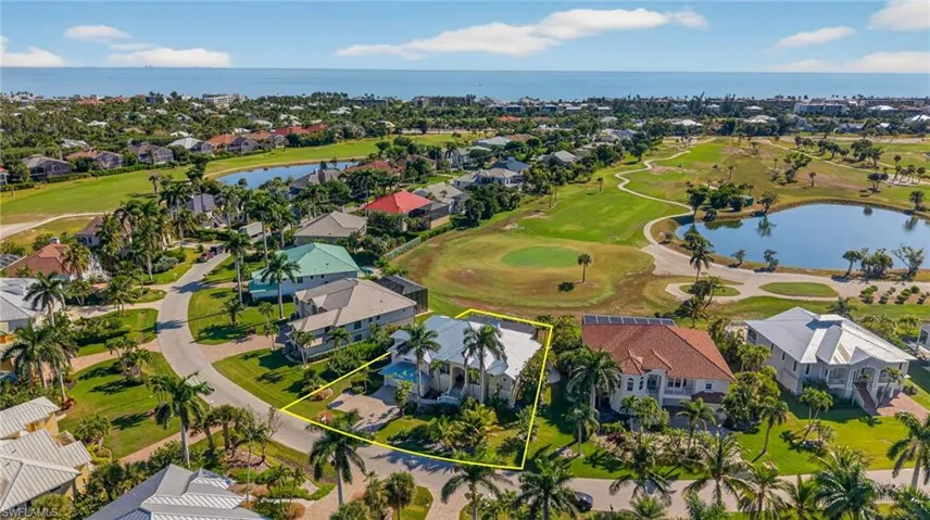 Aerial perspective of suburban area featuring a nearby body of water, a local golf course, and property parcel outlined