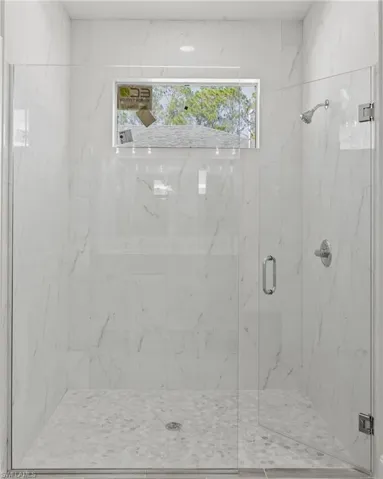 Bathroom with a healthy amount of sunlight and an enclosed shower