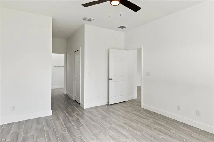 Unfurnished bedroom with light hardwood / wood-style flooring, a closet, and ceiling fan