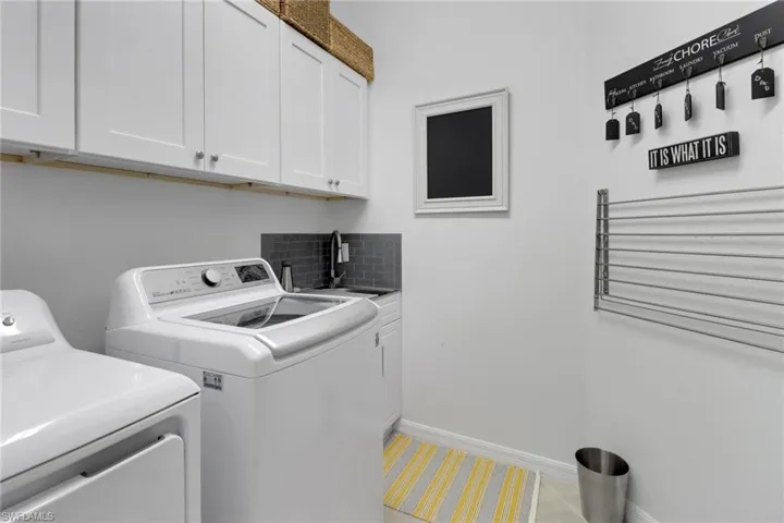 Laundry room with sink and ample storage