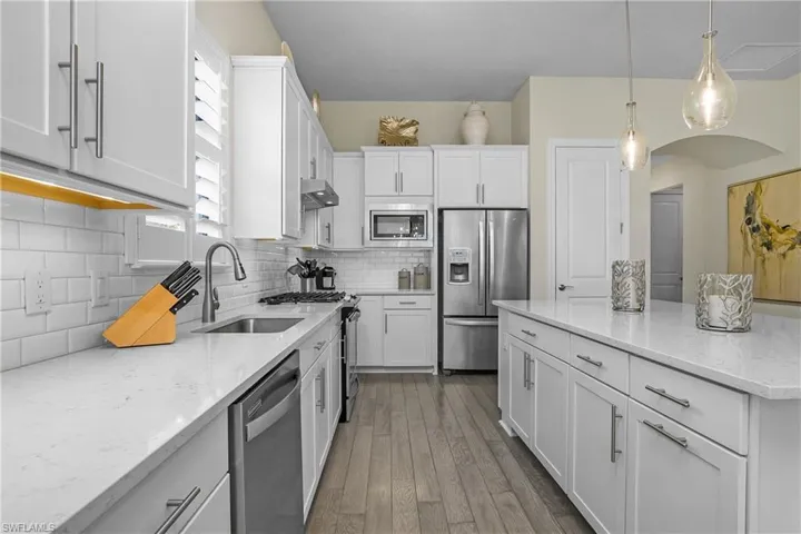 Note the under-cabinet lighting in the kitchen creating a bright and inviting space.