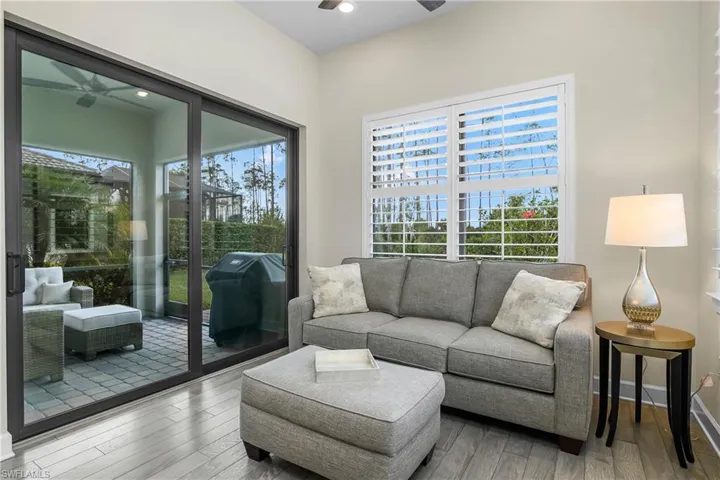 Sun room with sliders leading to screened outdoor lanai.