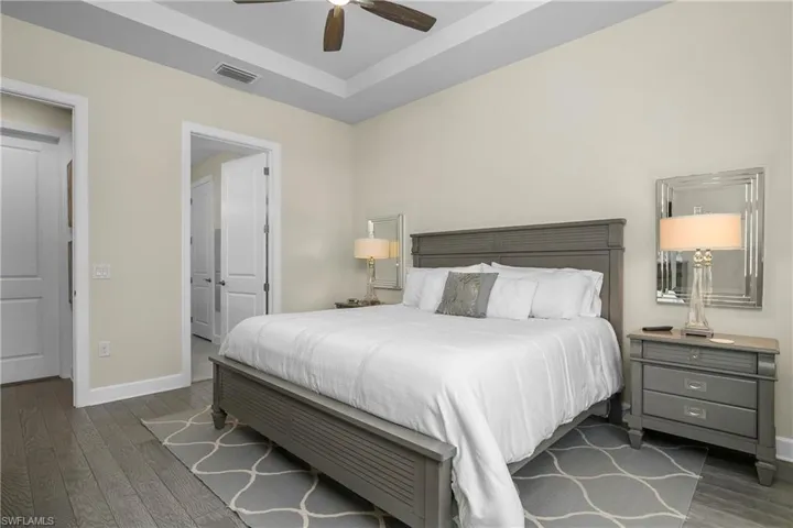 Owner suite is spacious and includes tray ceiling, hardwood flooring, and ensuite bath.