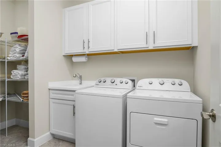 You'll LOVE the location of the laundry room, which includes additional cabinets, utility sink, and another storage closet for all your linens!