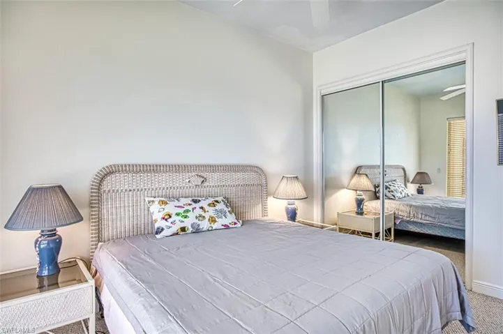 Carpeted bedroom with a closet and ceiling fan