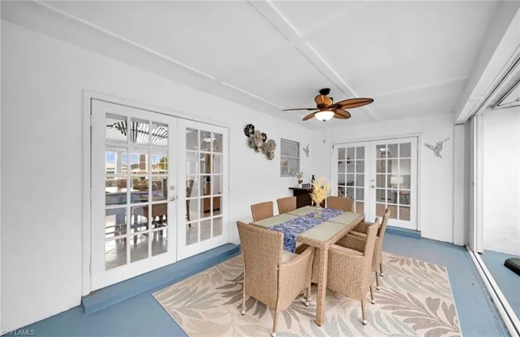 Sunroom / solarium featuring french doors