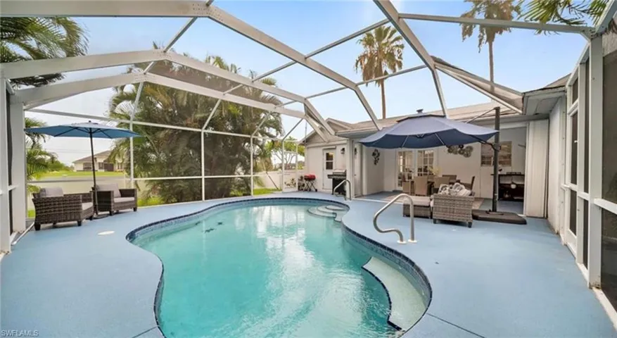 Swimming pool featuring a lanai, a patio area, and an outdoor hangout area