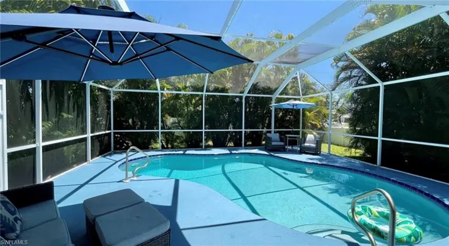 Outdoor pool featuring a lanai, a patio area, and a sunroom