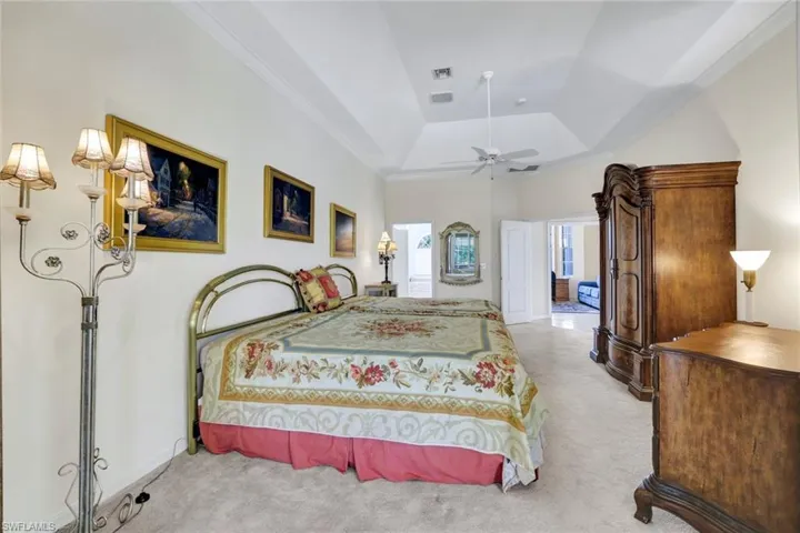 This view of the Primary Bedroom shows the entrance to the ensuite bathroom as well as the main double door entry to the bedroom.