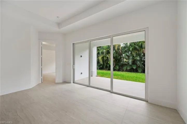 Unfurnished bedroom with access to outside and light wood-style flooring