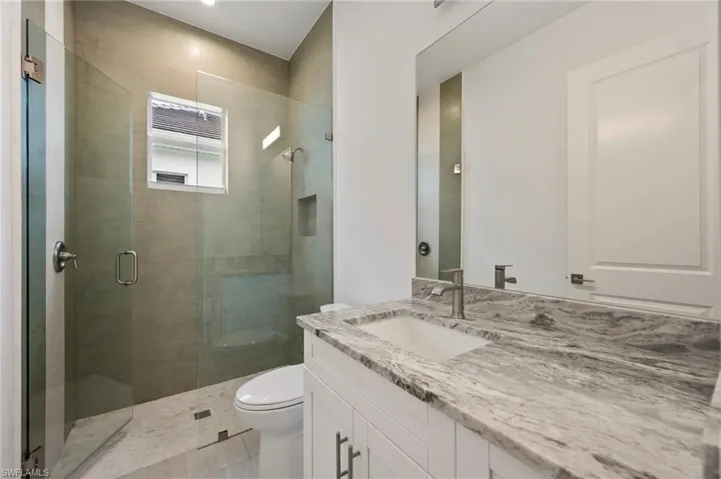 Bathroom featuring vanity and a stall shower