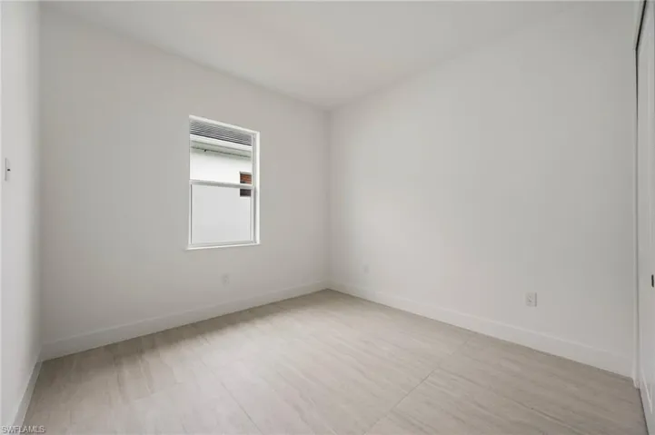 Empty room featuring baseboards and light wood finished floors