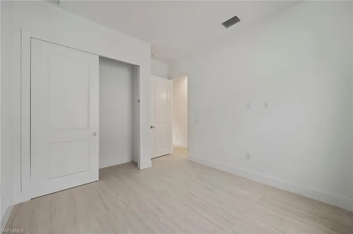 Unfurnished bedroom featuring a closet and light wood-type flooring