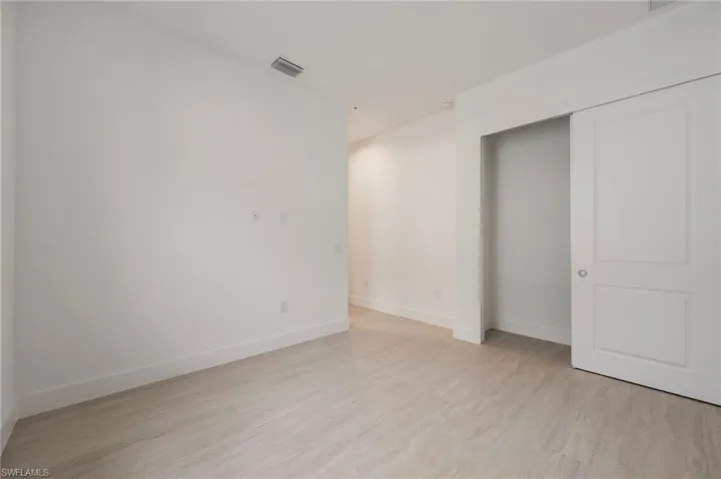 Unfurnished room featuring baseboards and light wood-style floors