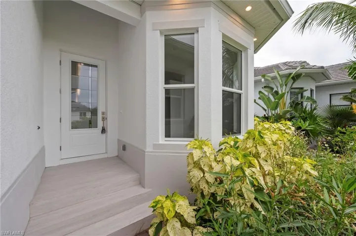 Entrance to property with stucco siding