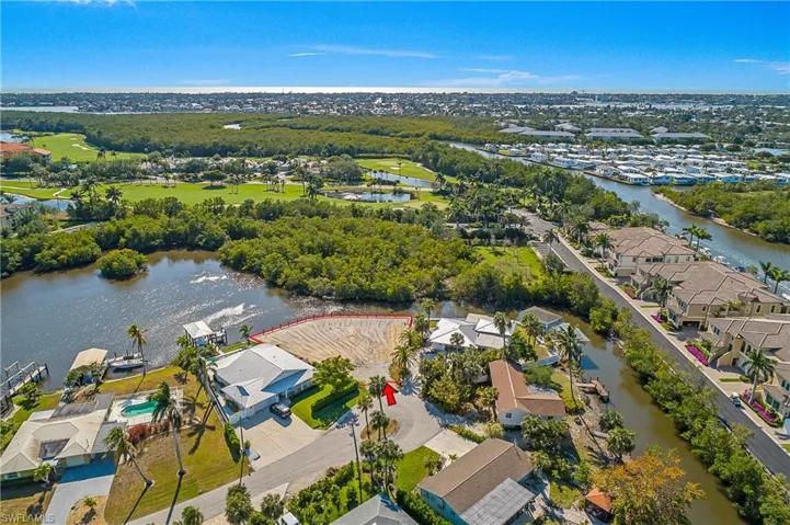 Aerial perspective of suburban area featuring a large body of water