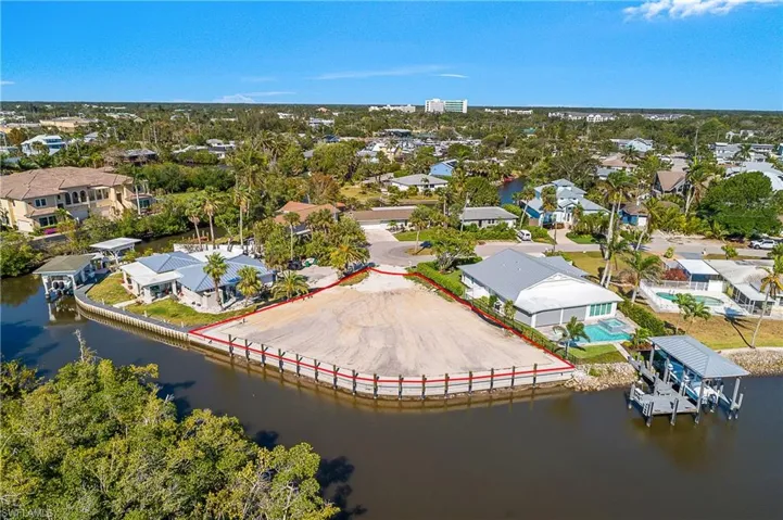 Aerial view of residential area featuring a nearby body of water