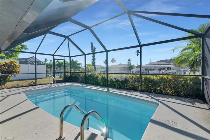 Swimming pool featuring a sunroom, a lanai, and a patio area