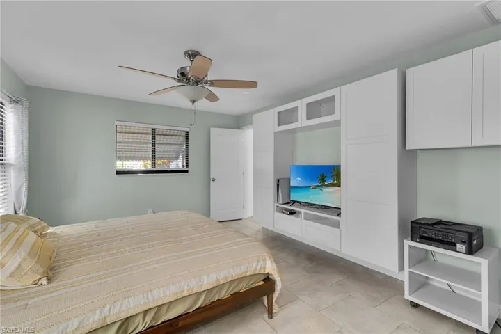 Bedroom featuring a ceiling fan and light tile patterned flooring