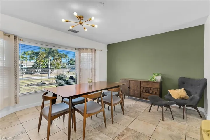 Dining area with a chandelier and light tile patterned floors