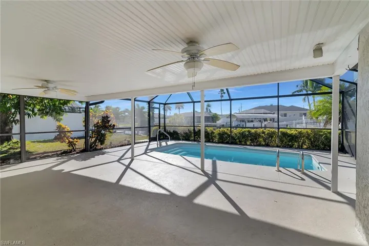 Outdoor pool with a lanai, a sunroom, and a patio