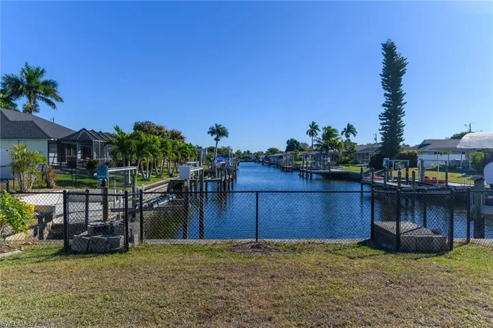 Dock area featuring a water view, a residential view, and boat lift