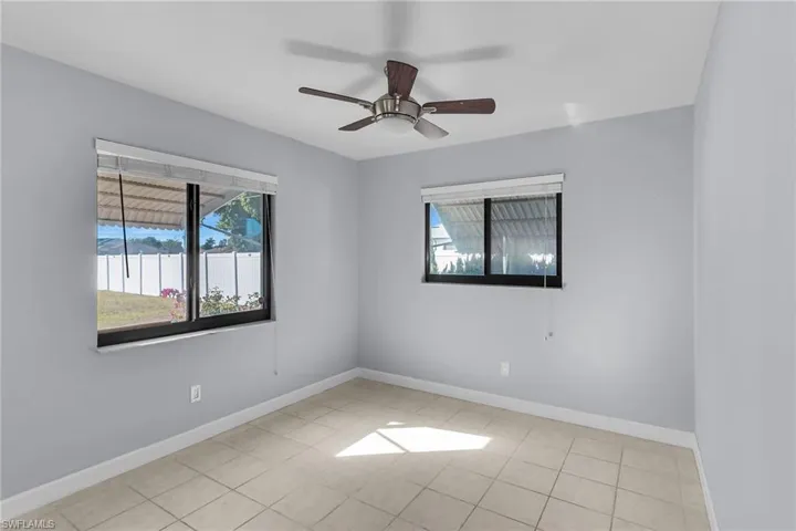 Unfurnished room with a ceiling fan and light tile patterned floors