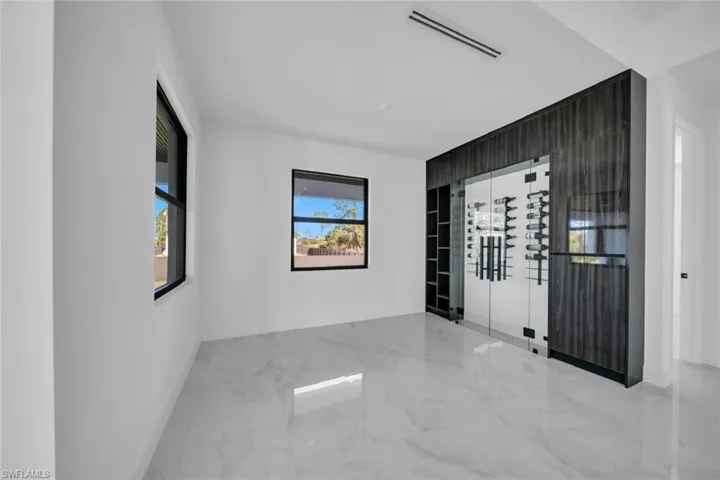 Spare room featuring baseboards and marble tiled floors