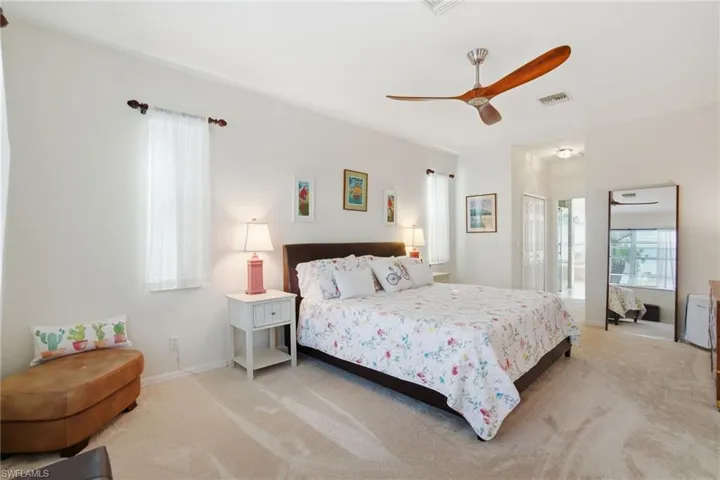 Spacious primary suite features dual walk-in closets and a beautifully upgraded ensuite bath (2024) with dual vanities, a separate soaking tub, and a frameless glass shower enclosure.
