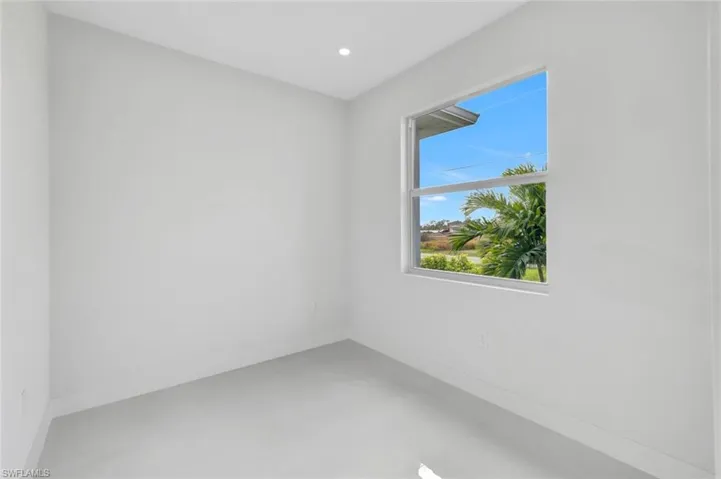 Spare room with concrete floors and recessed lighting