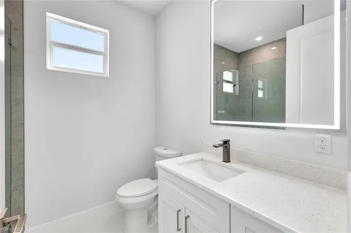 Full bath featuring vanity and a shower stall