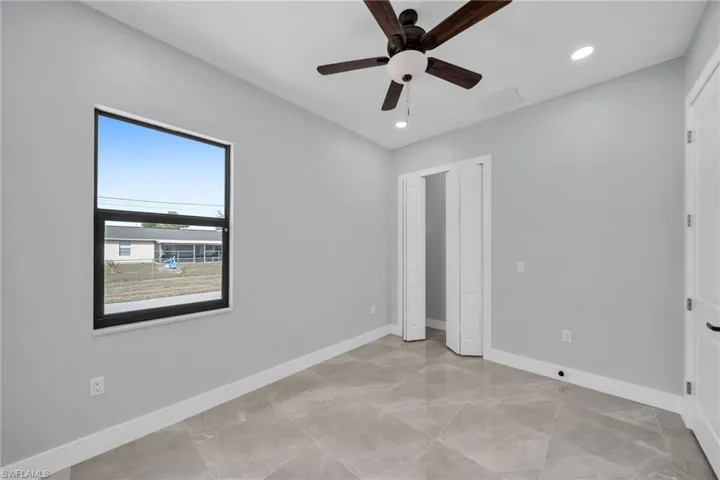 Unfurnished bedroom featuring ceiling fan