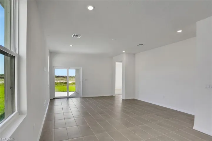 Empty room featuring recessed lighting and light tile patterned floors