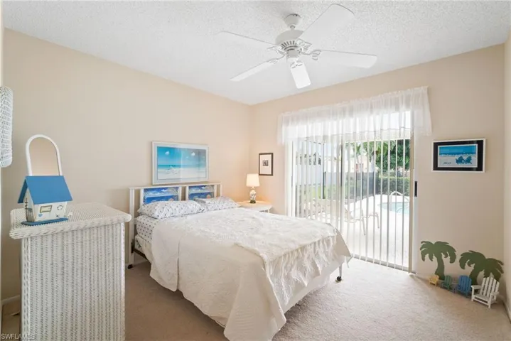 Carpeted bedroom with access to pool